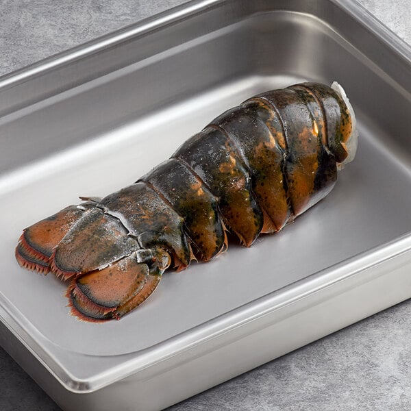 A Boston Lobster Company 8-10 oz. lobster tail in a metal pan.