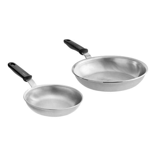A pair of Vollrath aluminum frying pans with blue Cool Handles.