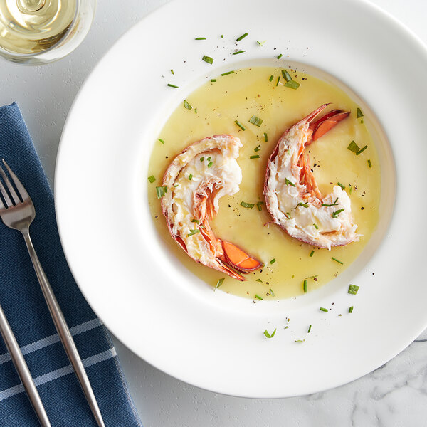 A white plate with a Boston Lobster Company lobster tail and a glass of wine.
