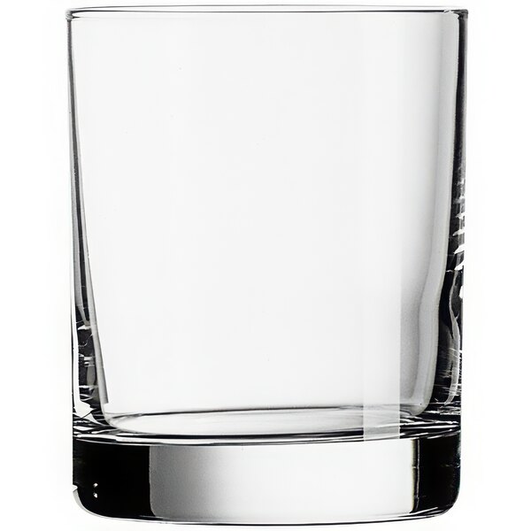 An Arcoroc Aristocrat old fashioned glass filled with whiskey on a white background.