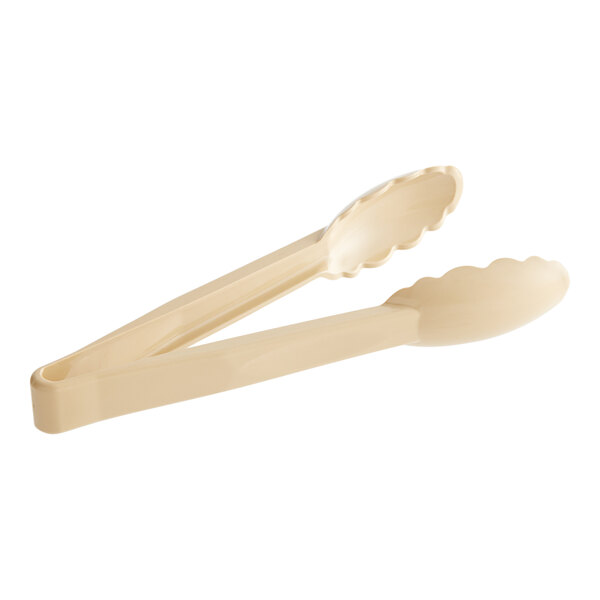 A pair of beige Cambro tongs with scalloped handles.