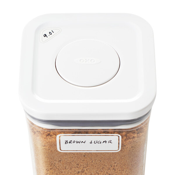 A white OXO container with a lid and a brown sugar label.