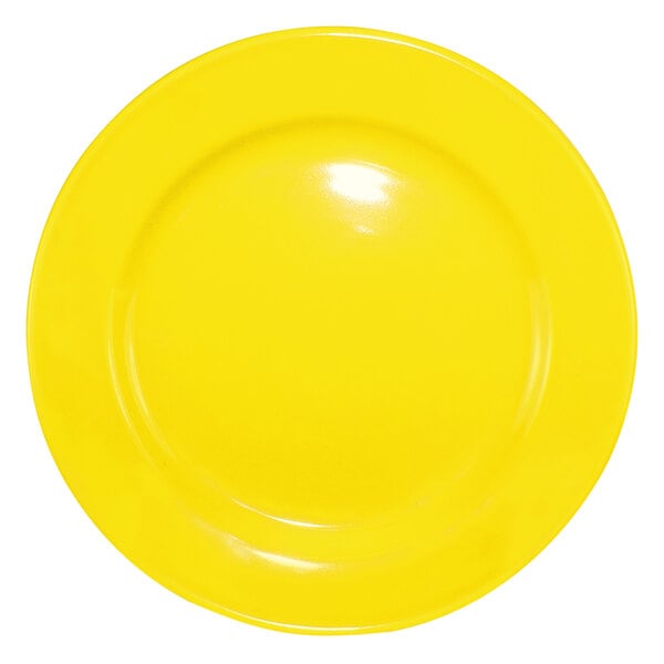 A yellow International Tableware stoneware plate with a white rolled edge.