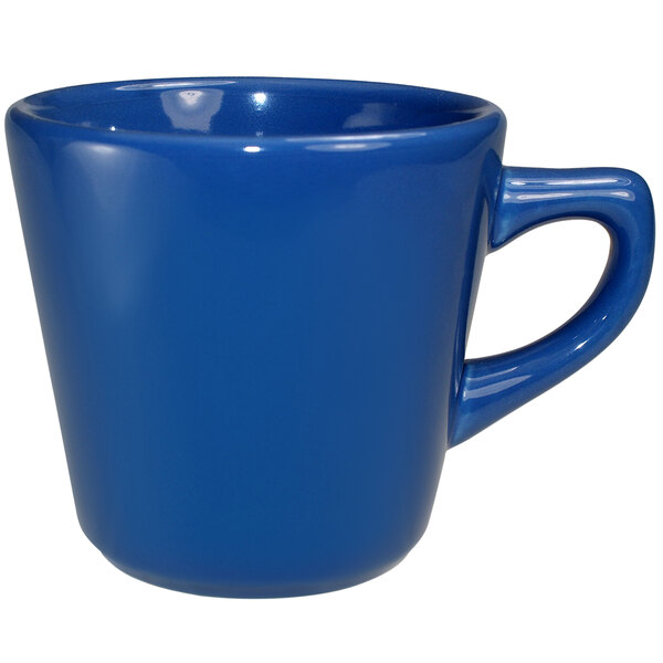 A light blue stoneware tall cup with a handle.