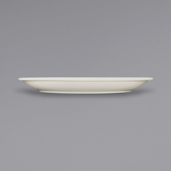An ivory stoneware plate with a narrow rim.