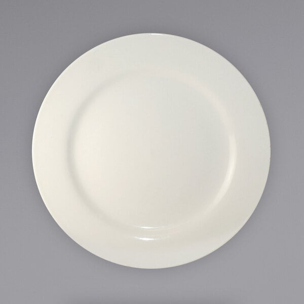 An International Tableware Roma stoneware plate with a white rim on a gray background.