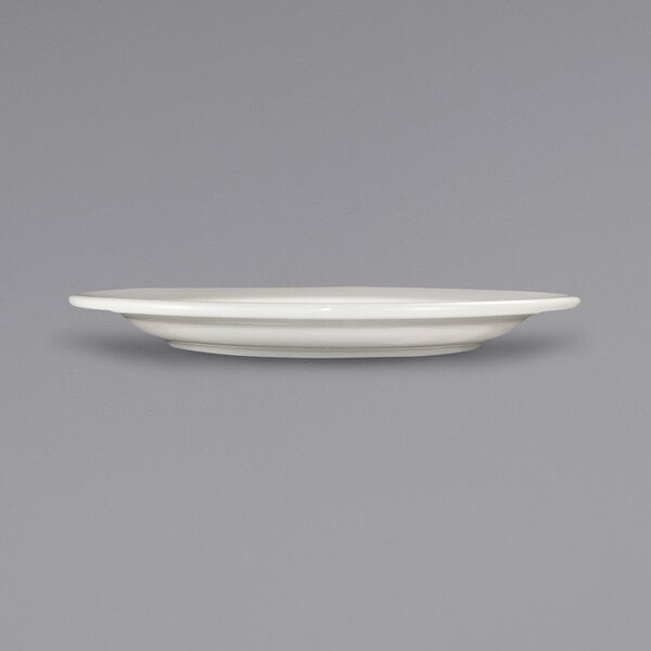 An International Tableware Roma ivory stoneware plate with a wide rim.