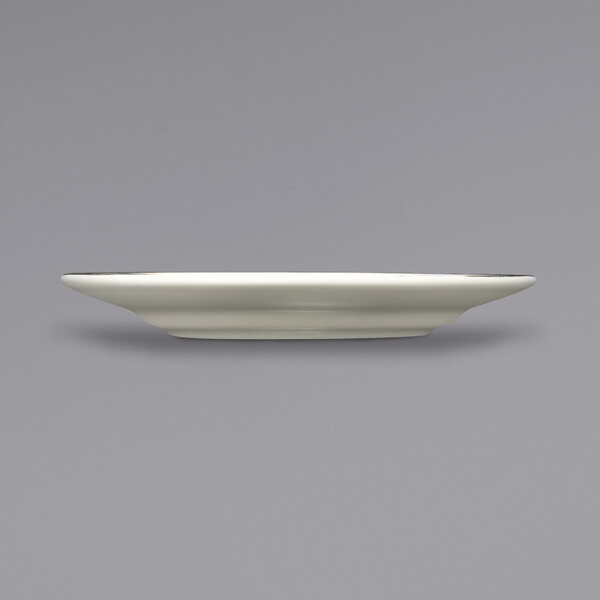 A white saucer with a gold rim.