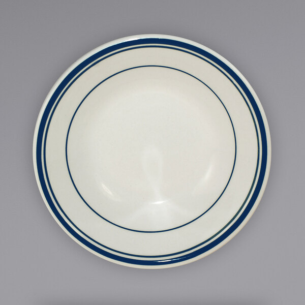 An ivory stoneware fruit bowl with blue bands around the rim.