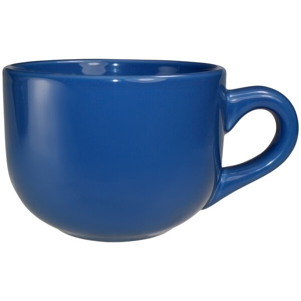 A close-up of a light blue International Tableware stoneware latte cup with a handle.