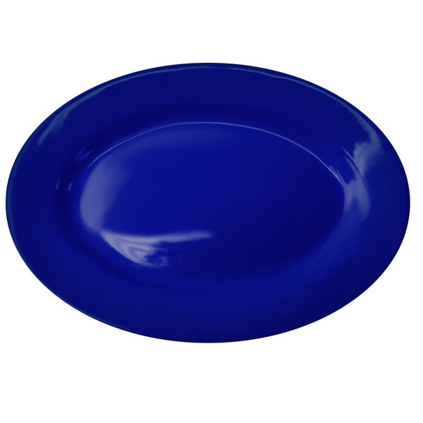 A cobalt blue International Tableware stoneware platter with a wide rim.
