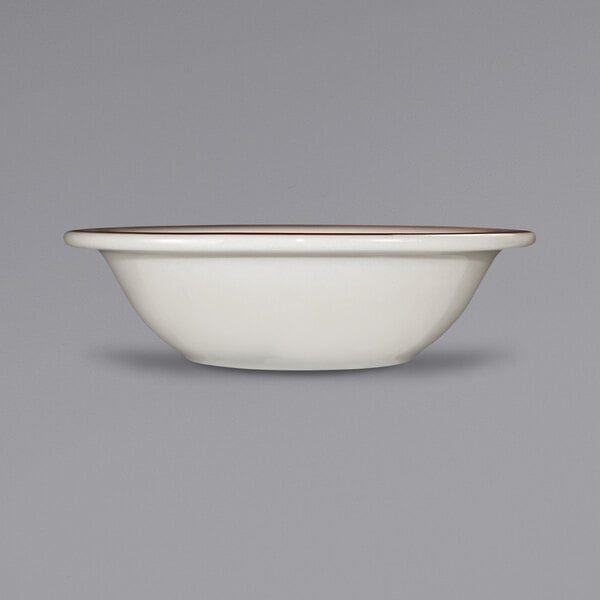 An International Tableware ivory stoneware bowl with a brown speckled rim.