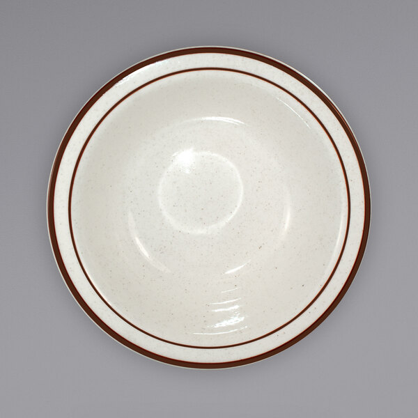 An International Tableware ivory stoneware grapefruit bowl with brown speckles and stripes.