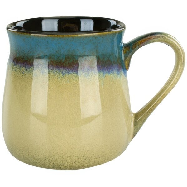 A close up of a blue and tan International Tableware Sioux Falls mug with a black rim.