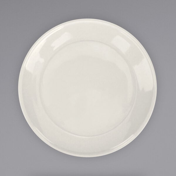 An International Tableware Roma stoneware plate with a wide white rim on a gray background.