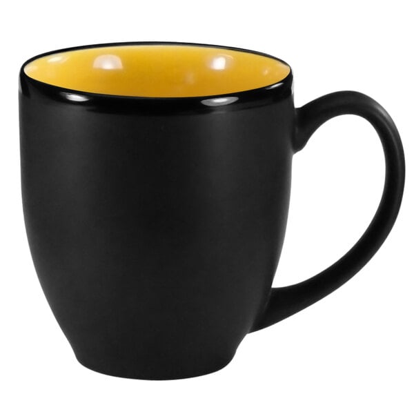 A black and yellow stoneware bistro cup with a handle.