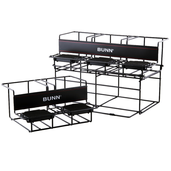 A black metal Bunn UNIV-5 APR two-tier rack with white trays on it.