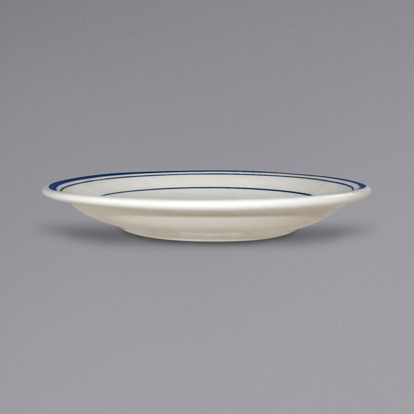 An International Tableware Catania saucer with blue bands on a white background.