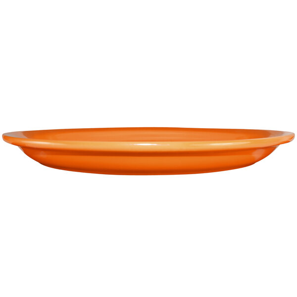 An orange stoneware platter with a narrow rim.