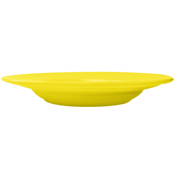 A yellow International Tableware stoneware pasta bowl.