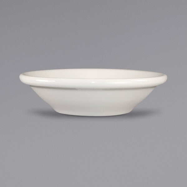 An International Tableware Roma stoneware fruit bowl in ivory on a gray surface.