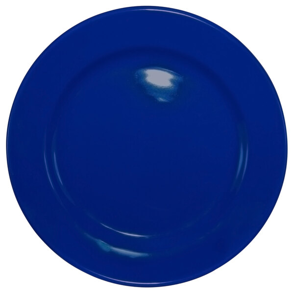 A cobalt blue stoneware plate with a wide rim and rolled edges.