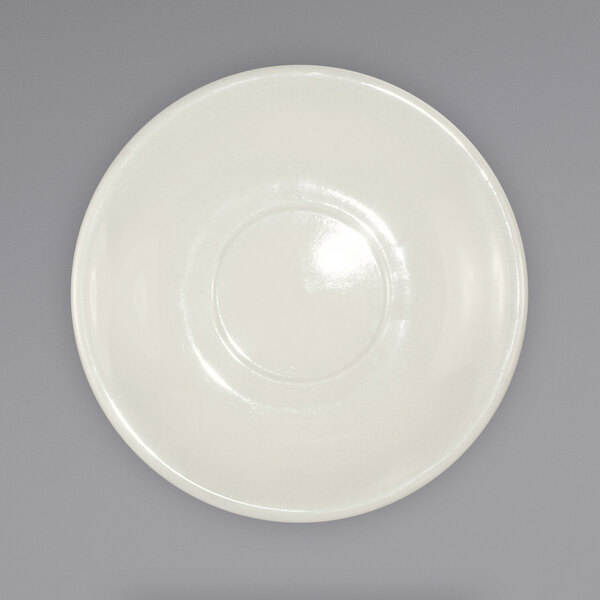 A white plate with a circular design on a gray surface.