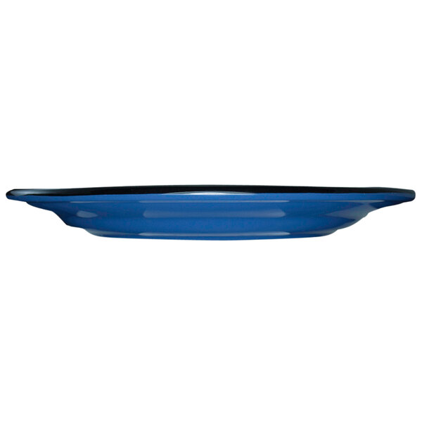 An ocean blue stoneware plate with a black rim.