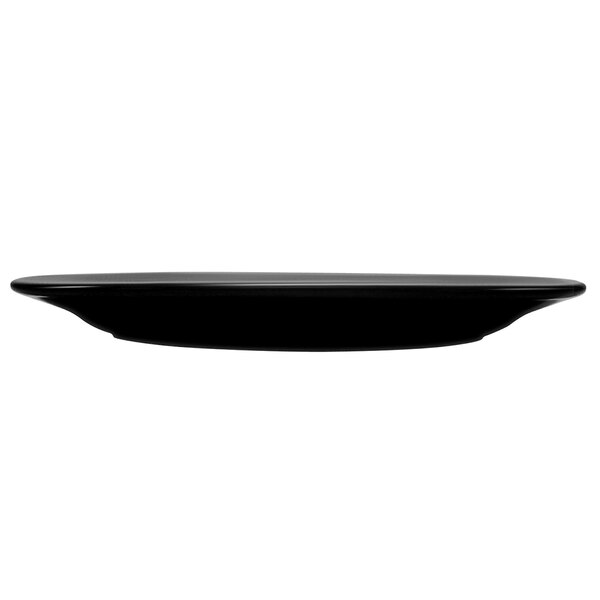 A black International Tableware stoneware platter with a wide rim.