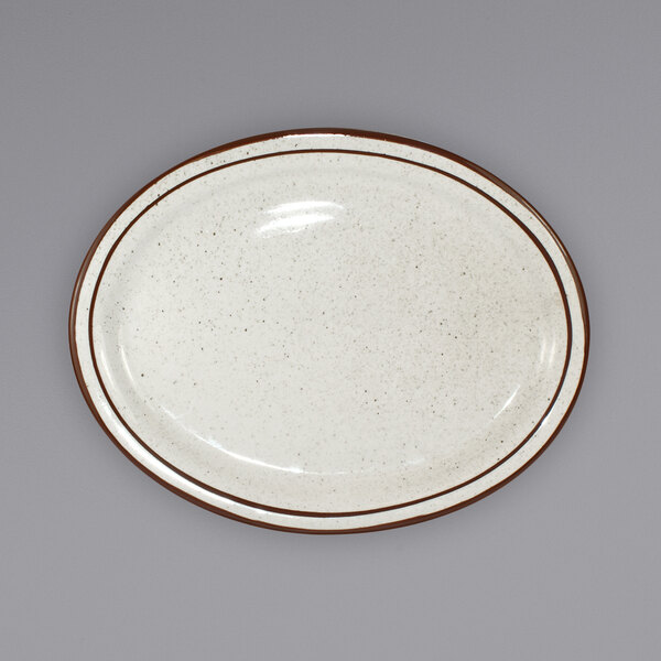 a white plate with brown speckled edges