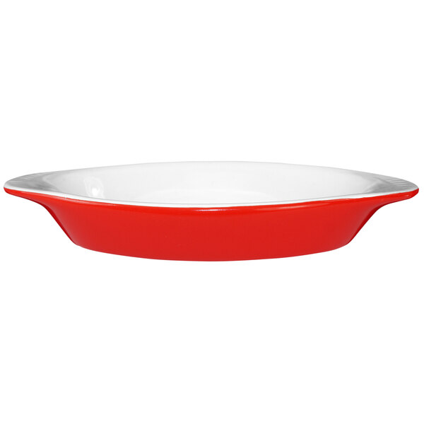 An oval crimson red and white rarebit dish with a rim.