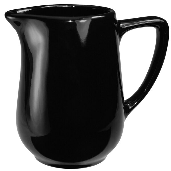 a black pitcher with a handle