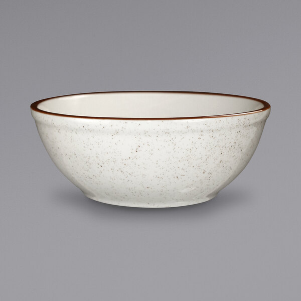 An International Tableware ivory stoneware bowl with a brown speckled rim.