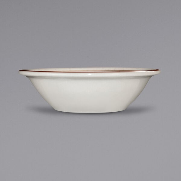 An International Tableware white stoneware fruit bowl with brown speckles on the rim.