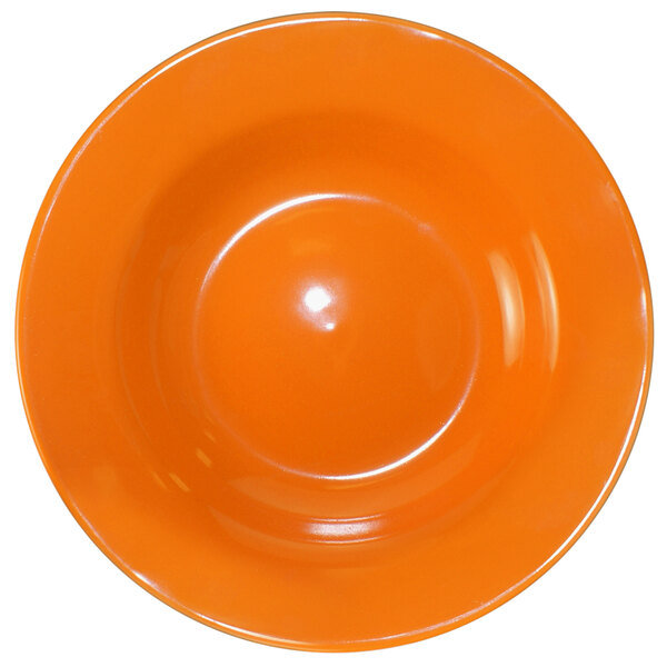 A close-up of an orange International Tableware stoneware bowl.