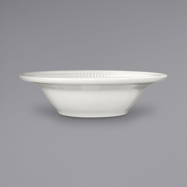 An International Tableware Athena stoneware bowl with a wide rim on a gray background.