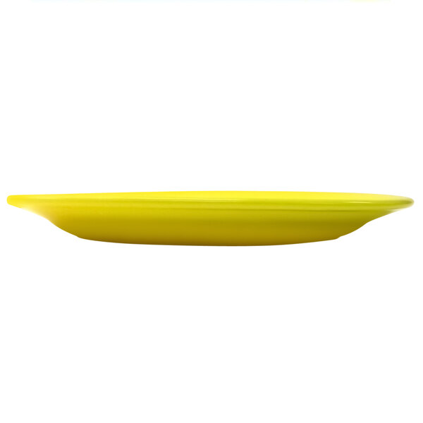 A yellow stoneware platter with a wide rim.