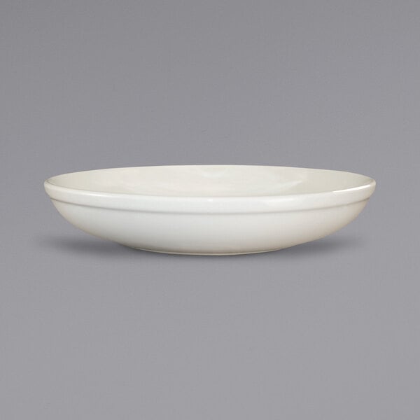 An ivory stoneware salad bowl with a rolled edge.