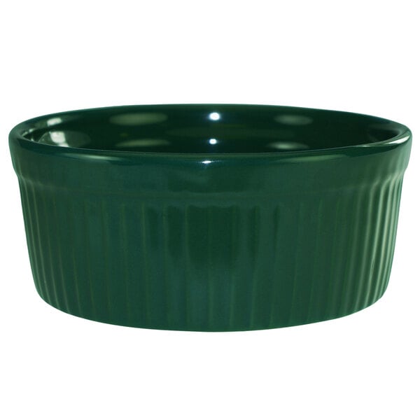 A green fluted stoneware ramekin with a rim.