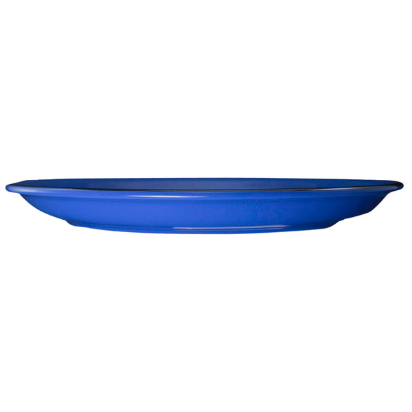 A blue International Tableware stoneware plate with a rim.