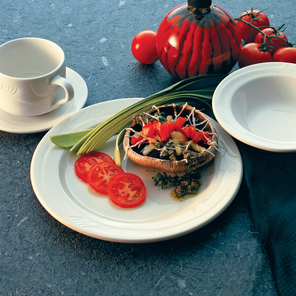 An ivory stoneware plate with food on it.