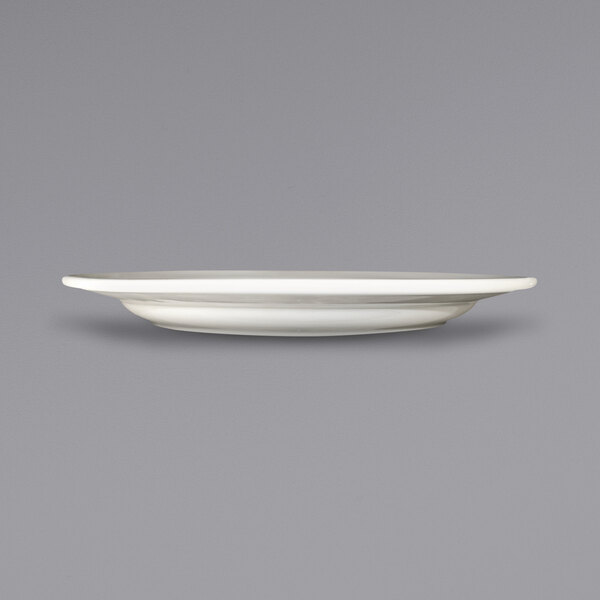 A white International Tableware Newport stoneware plate with an embossed rim.
