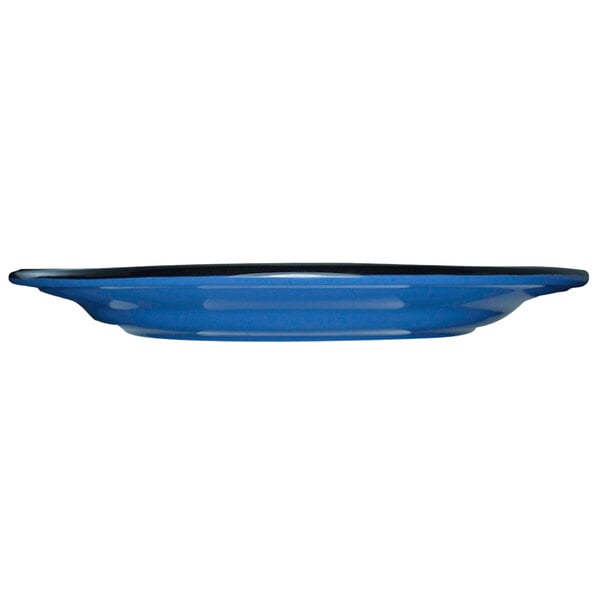 A blue stoneware plate with a black rim.