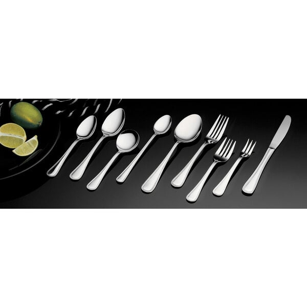 A close-up of a Vollrath stainless steel serving spoon with a brocade design.