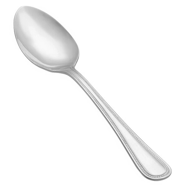 A Vollrath stainless steel serving spoon with a brocade handle.