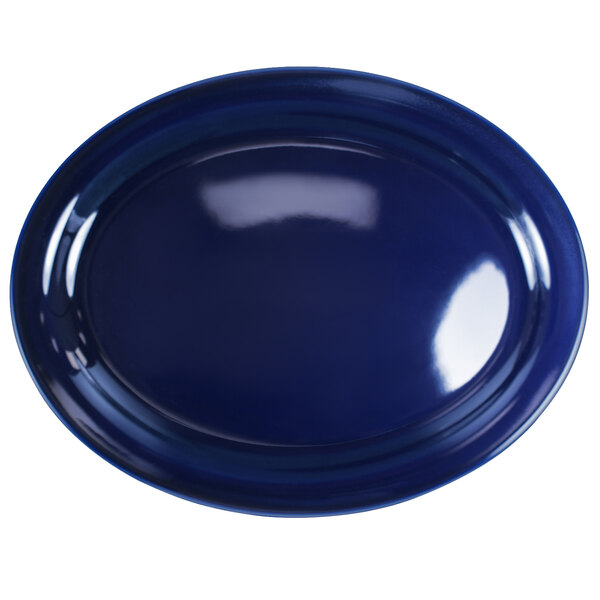 A cobalt blue stoneware oval platter with a narrow rim.