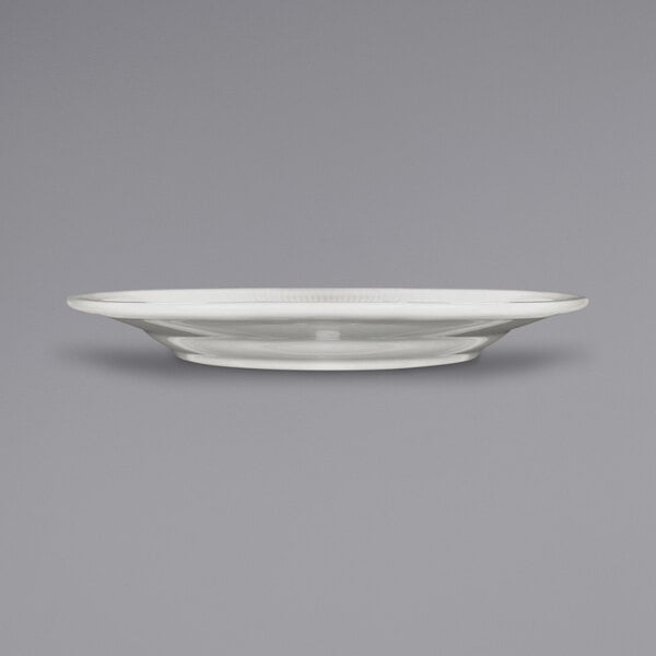 An International Tableware ivory stoneware plate with a wide rim.