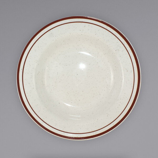 A white bowl with a brown speckled rim.