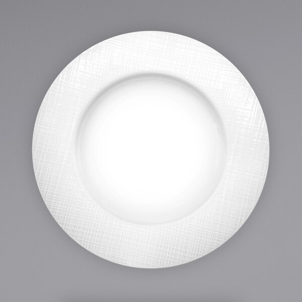 A bright white porcelain pasta bowl with a textured rim.