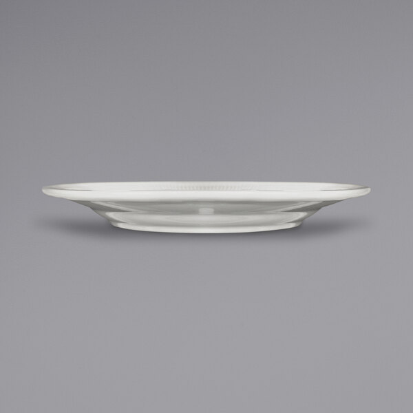 An International Tableware ivory stoneware plate with a wide rim.